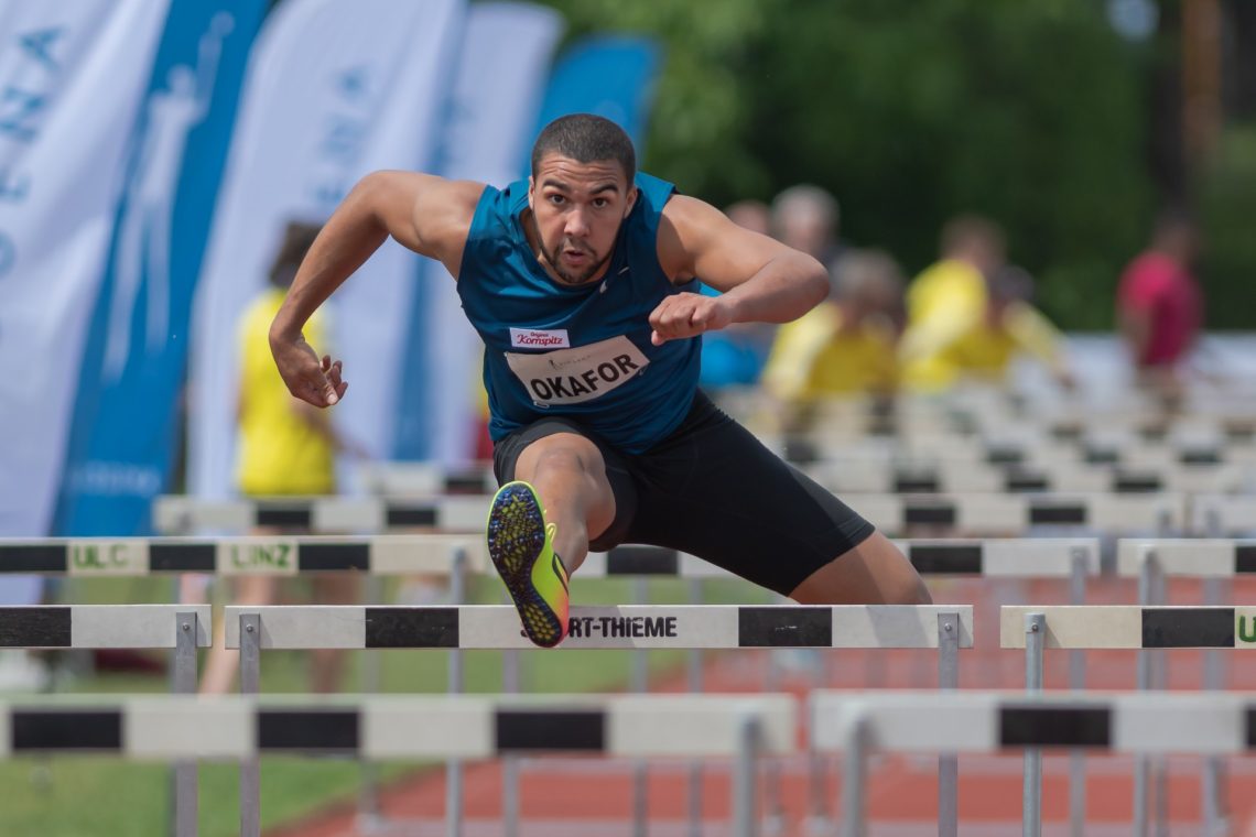 Man jumping over hurdle