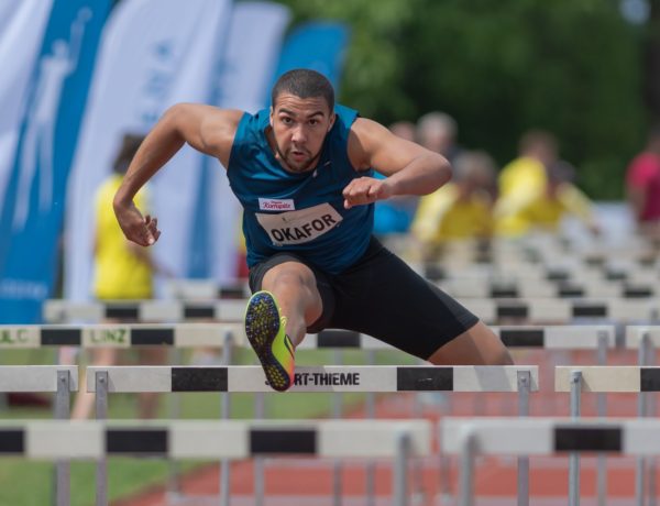 Man jumping over hurdle